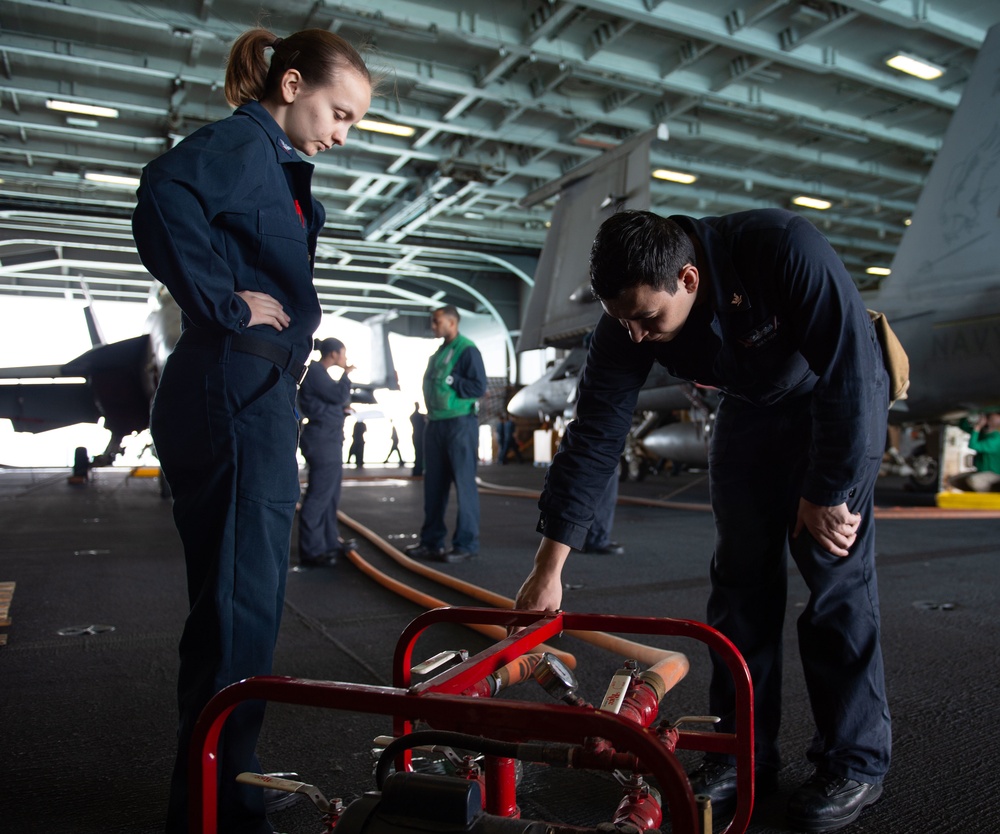 U.S. Sailors prepare for a fire hose hydrostatic test