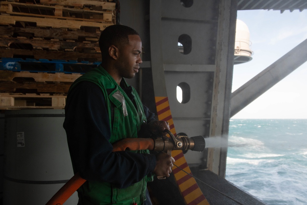 U.S Sailor discharges a fire hose