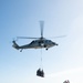 U.S. Sailor directs an MH-60S Knight Hawk