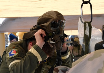 Aircrew members train with chemical gear