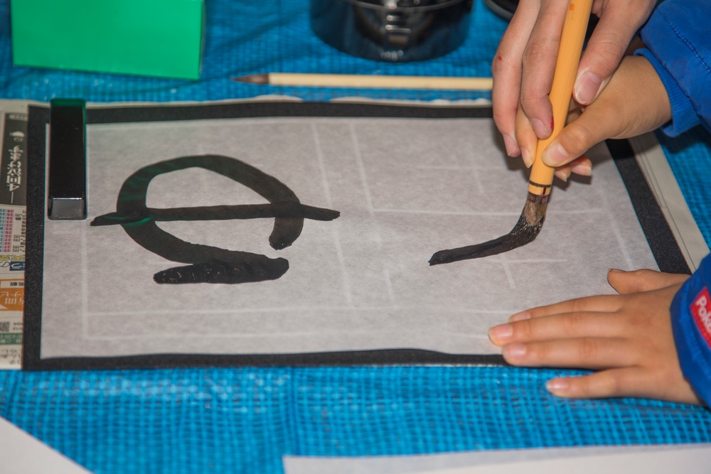 Girl Scouts write in the new year with Kakizome
