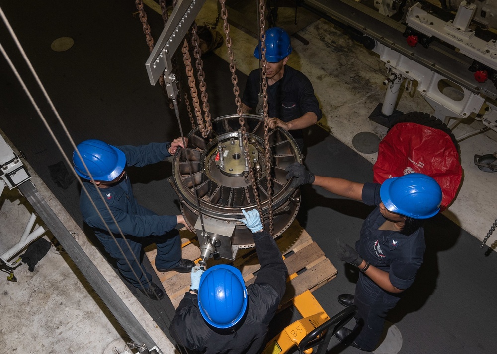 U.S. Sailors raise a jet engine