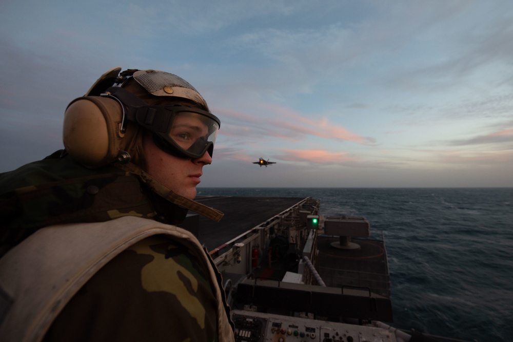 U.S. Sailor stands watch aboard the aircraft carrier USS John C. Stennis (CVN 74)