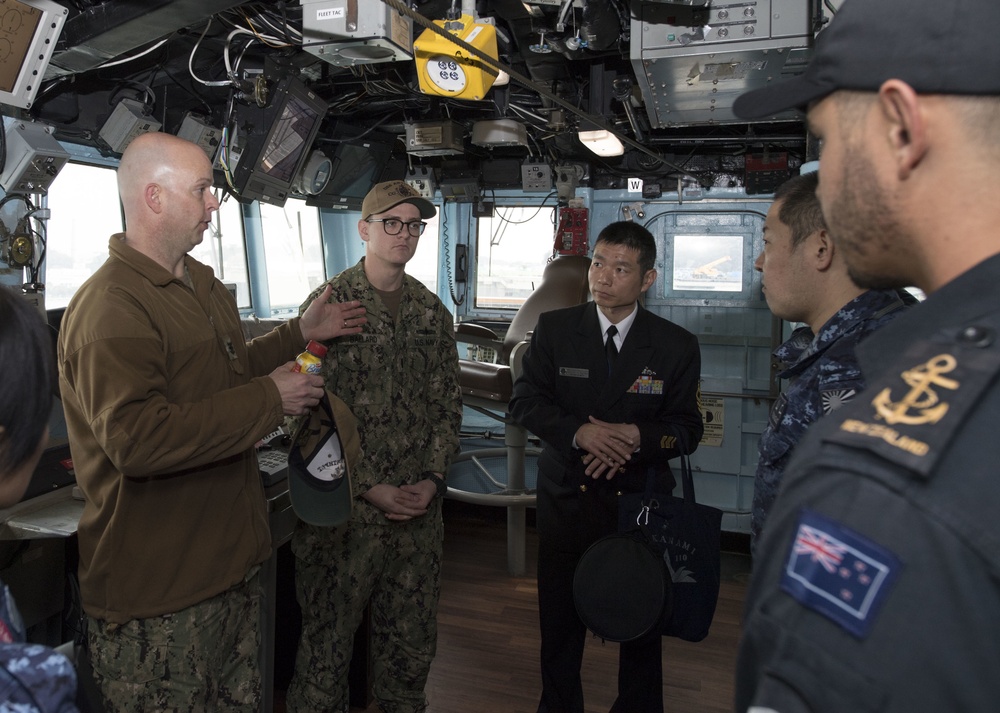 aster Chief Benjamin Howat, 7th Fleet Command Master Chief, speaks with Sailors from the Royal New Zealand Navy in the bridge of the Ticonderoga-class guided-missile cruiser USS Antietam (CG 54) during the Sailor of the Year competition at Fleet Activites