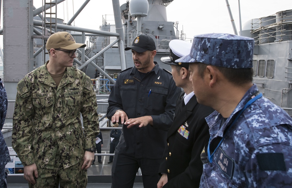 A member of the Japan Maritime Self-Defense Forces (JMSDF) asks a question while on a tour on the Ticonderoga-class guided-missile cruiser USS Antietam (CG 54) during the Sailor of the Year competition at Fleet Activites Yokosuka