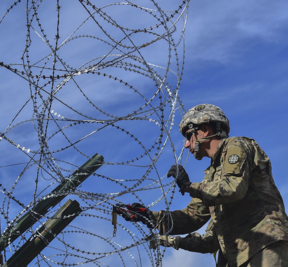 Soldier Hangs Concertina Wire Along the Southwest Border