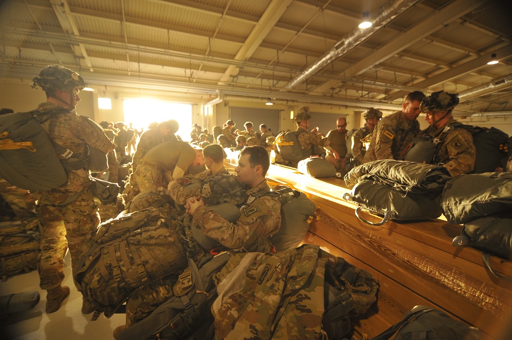 Jumpmasters check paratroopers before night jump