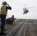 U.S. Navy Boatswain’s Mate 3rd Class Brandon Ross, from Honeapath, South Carolina, signals the pilot of a Panther anti-submarine helicopter