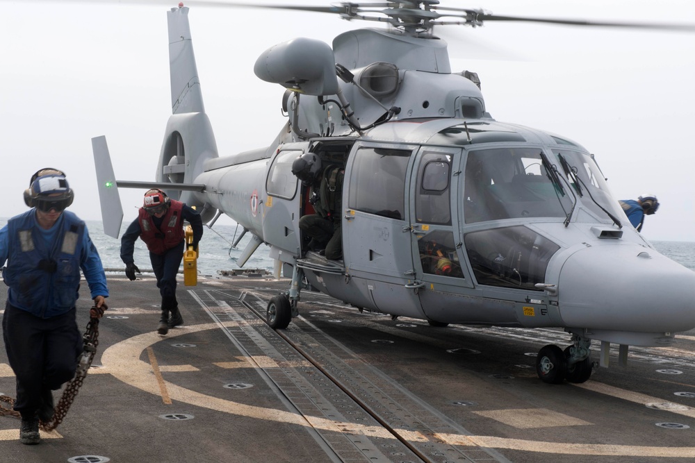 U.S. Navy Seaman Garrett Cardenas, left, from Ward, Arizona, and Boatswain’s Mate 3rd Class James Ramsdell, from Phoenix, remove chocks and chains from a Panther anti-submarine helicopter