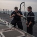 U.S. Navy Gunner's Mate 1st Class Dustin Smillie, from Prescott, Arkansas, left, explains the functions of a vertical launch system to French Marine Nationale Second-maître Martin, aboard USS Mobile Bay (CG 53)