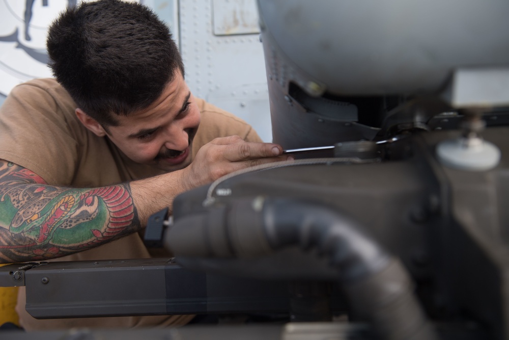 U.S. Navy Aviation Machinist’s Mate 2nd Class Frank Rivero, from Miami, uses a wrench on an MH-60R Sea Hawk