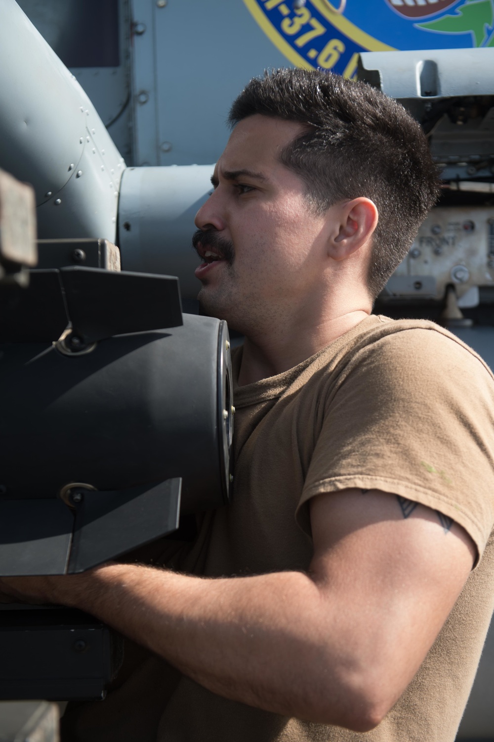 U.S. Navy Aviation Machinist’s Mate 2nd Class Frank Rivero, from Miami, loads an AGM-114 Hellfire missile