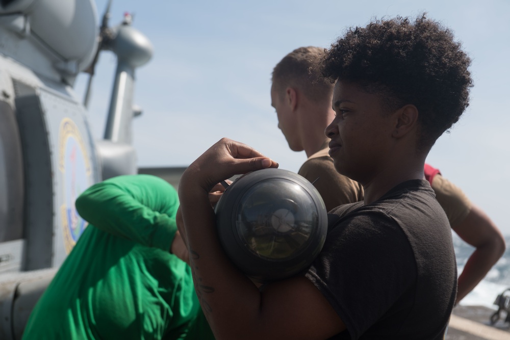 U.S. Navy Aviation Structural Mechanic 2nd Class Jasmine Tipton, from Nashville, Tennessee, transports an AGM-114 Hellfire missile