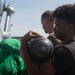 U.S. Navy Aviation Structural Mechanic 2nd Class Jasmine Tipton, from Nashville, Tennessee, transports an AGM-114 Hellfire missile