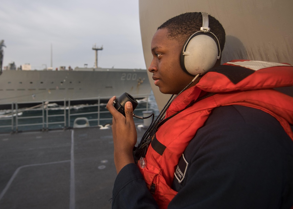 U.S. Navy Personnel Specialist Seaman Devin Coleman, from Jacksonville, Florida, communicates with the fleet replenishment oiler USNS Guadalupe