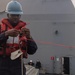 U.S. Navy Counselor 1st Class Demarcus Lancaster, from Houston, ties a knot on the phone and distance line during a replenishment-at-sea