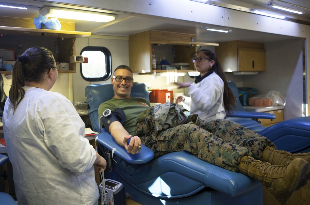 U.S. Navy Lt. j.g. Grant Eubanks donates blood during a blood drive