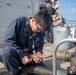 Dmage Controlmen Conduct Maintenance on a P-100 Pump