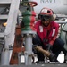 U.S. Sailor prepares an aqueous film forming foam hose