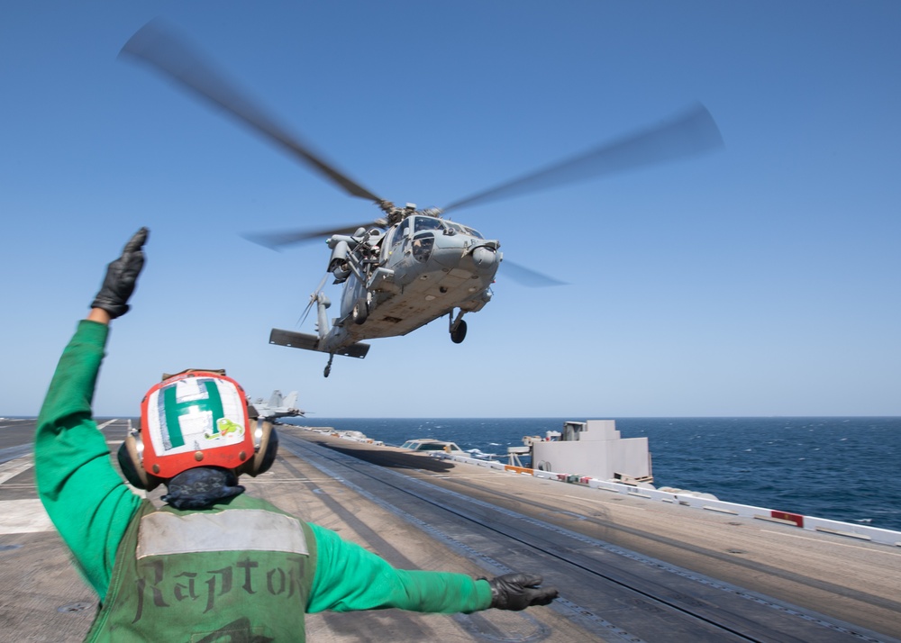 An MH-60S Seahawk lands on the flight deck of the aircraft carrier USS John C. Stennis (CVN 74)