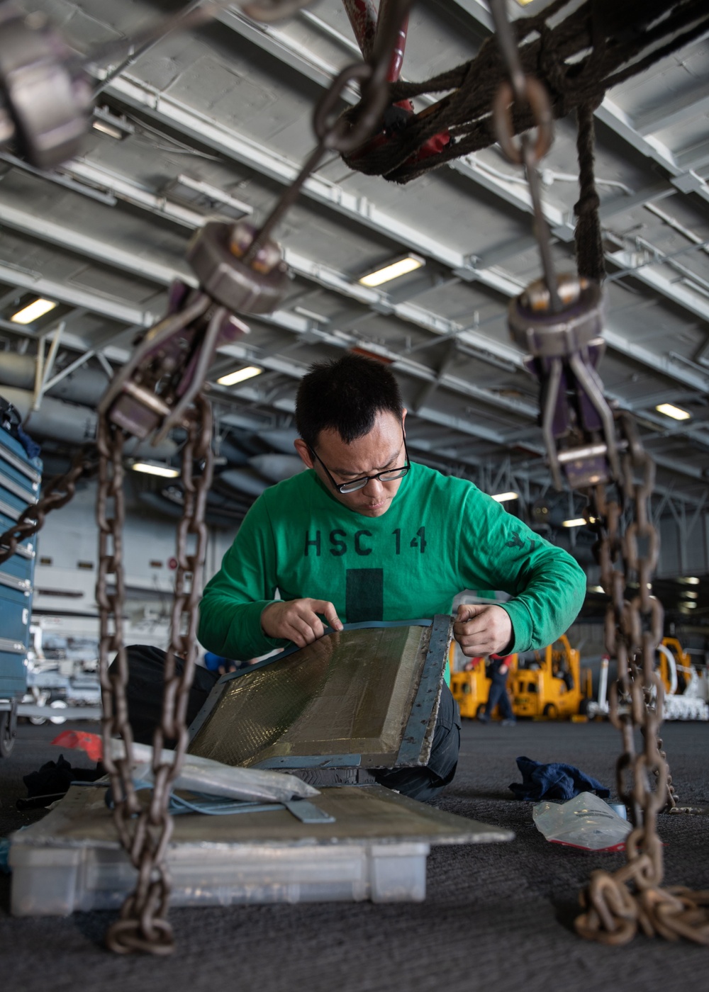 U.S. Sailors applies a new seal