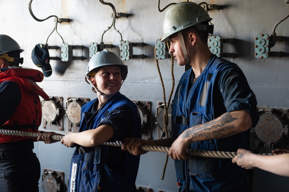 U.S. Sailors handle line