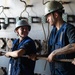 U.S. Sailors handle line