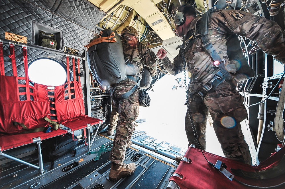 Paratrooper prepares to exit from CH-47 Chinook helicopter