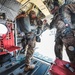 Paratrooper prepares to exit from CH-47 Chinook helicopter