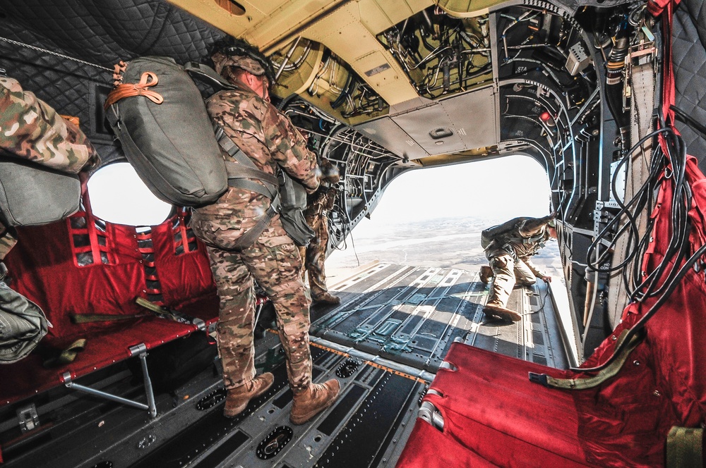 Paratroopers prepare to exit from CH-47 Chinook helicopter.