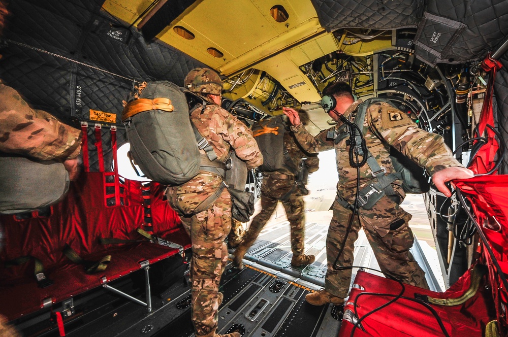 Paratroopers exit from CH-47 Chinook helicopter.