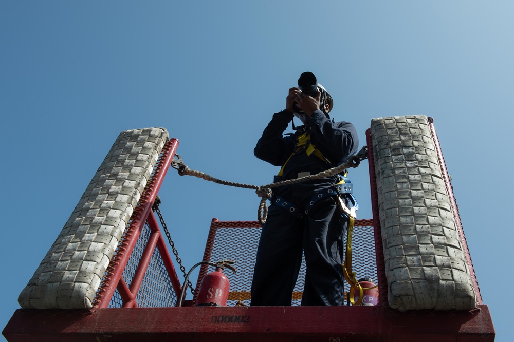 U.S. Sailor takes a photograph