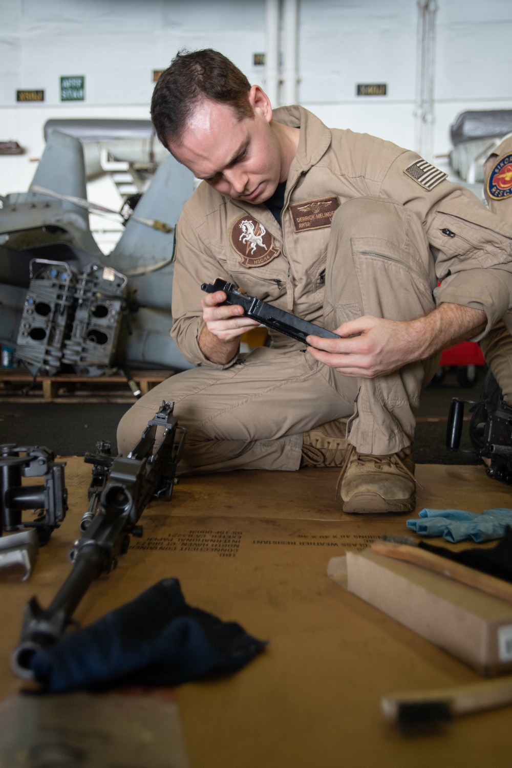 U.S. Sailor inspects a machine gun