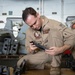 U.S. Sailor inspects a machine gun