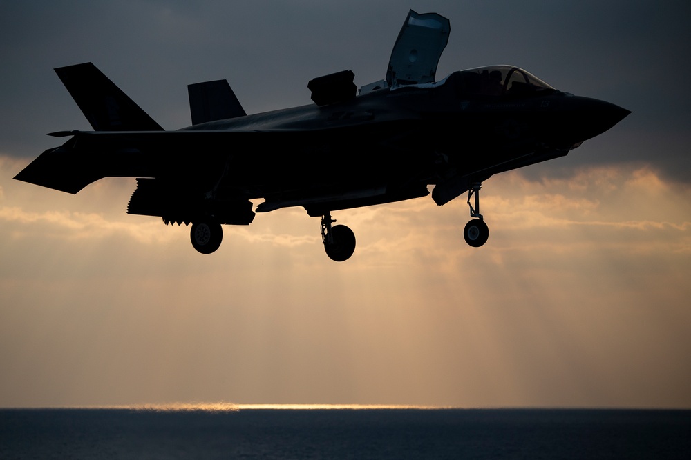 VMFA-121 naval aviators conduct flight operations at sunset aboard Wasp