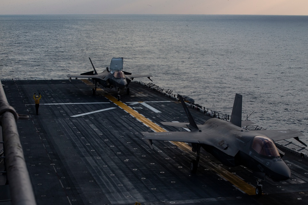 VMFA-121 naval aviators conduct flight operations at sunset aboard Wasp