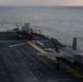 VMFA-121 naval aviators conduct flight operations at sunset aboard Wasp