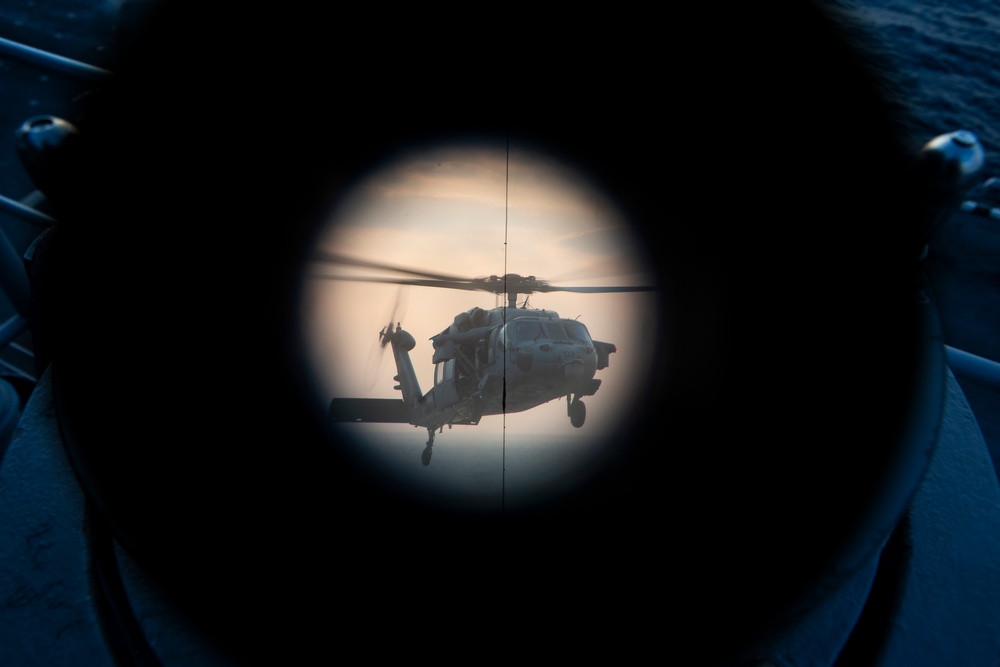 VMFA-121 naval aviators conduct flight operations at sunset aboard Wasp