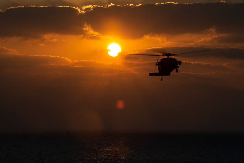 VMFA-121 naval aviators conduct flight operations at sunset aboard Wasp