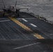 VMFA-121 naval aviators conduct flight operations at sunset aboard Wasp