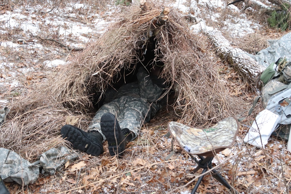 Cold-Weather Operations Course students build improvised shelters, survive outdoors