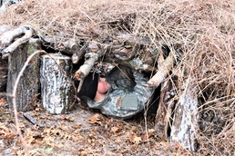 Cold-Weather Operations Course students build improvised shelters, survive outdoors