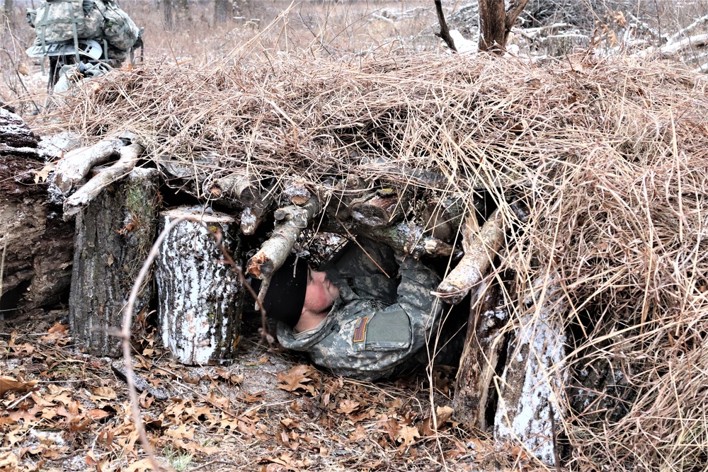 Cold-Weather Operations Course students build improvised shelters, survive outdoors