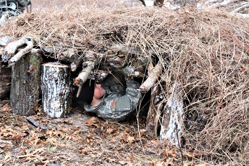 Cold-Weather Operations Course students build improvised shelters, survive outdoors