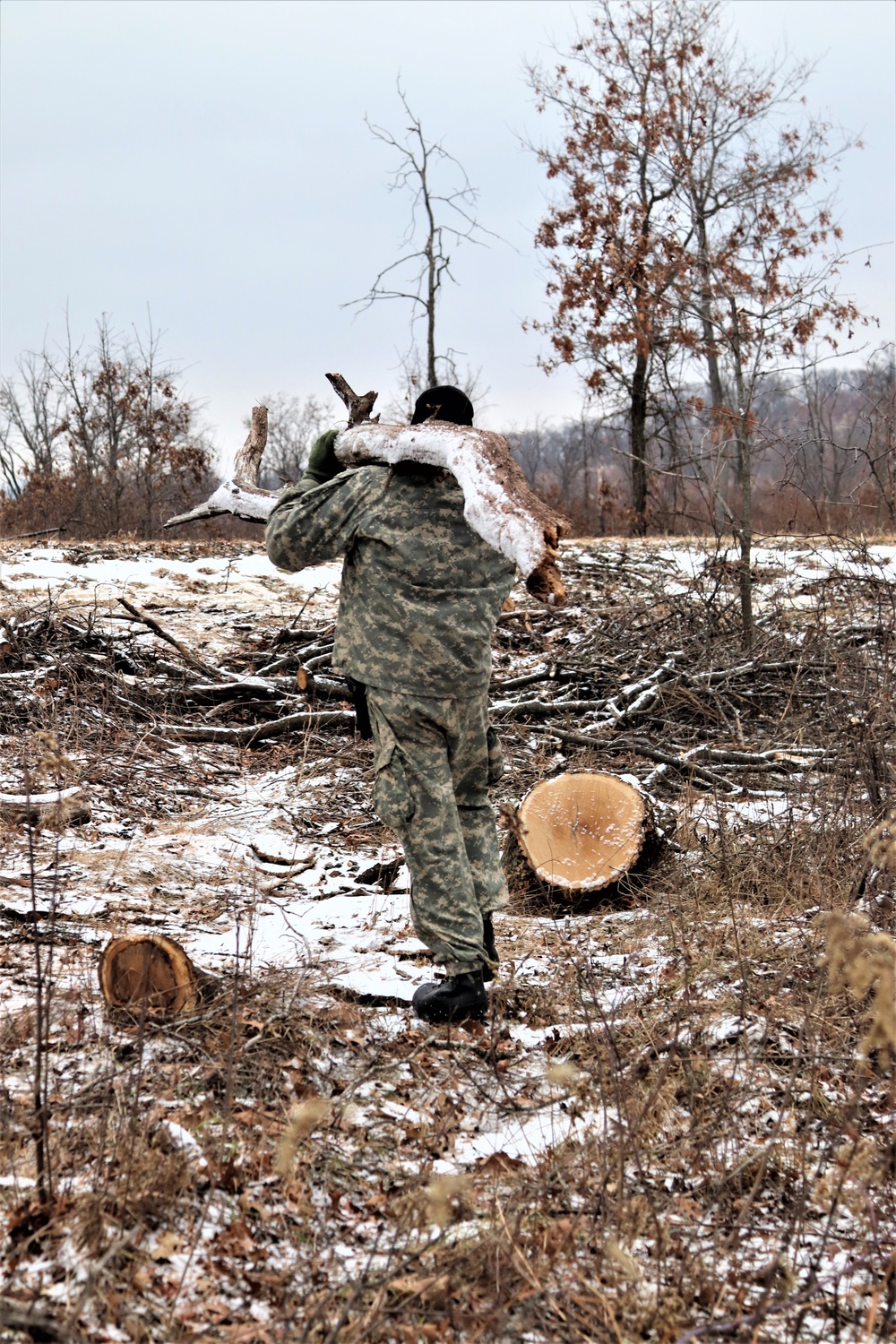 Cold-Weather Operations Course students build improvised shelters, survive outdoors