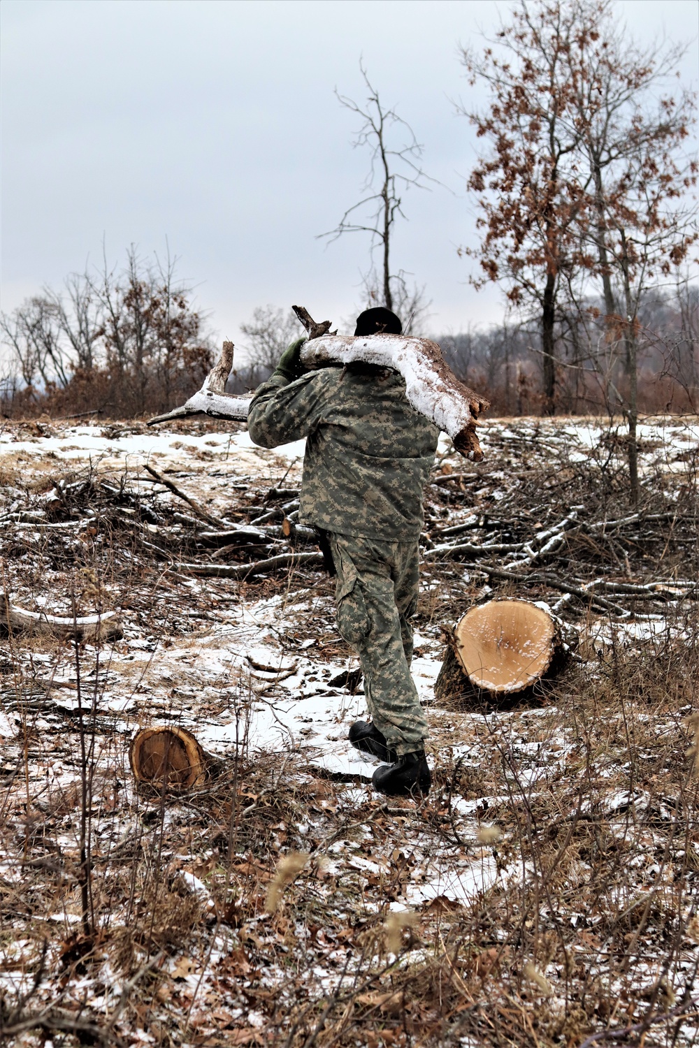 Cold-Weather Operations Course students build improvised shelters, survive outdoors