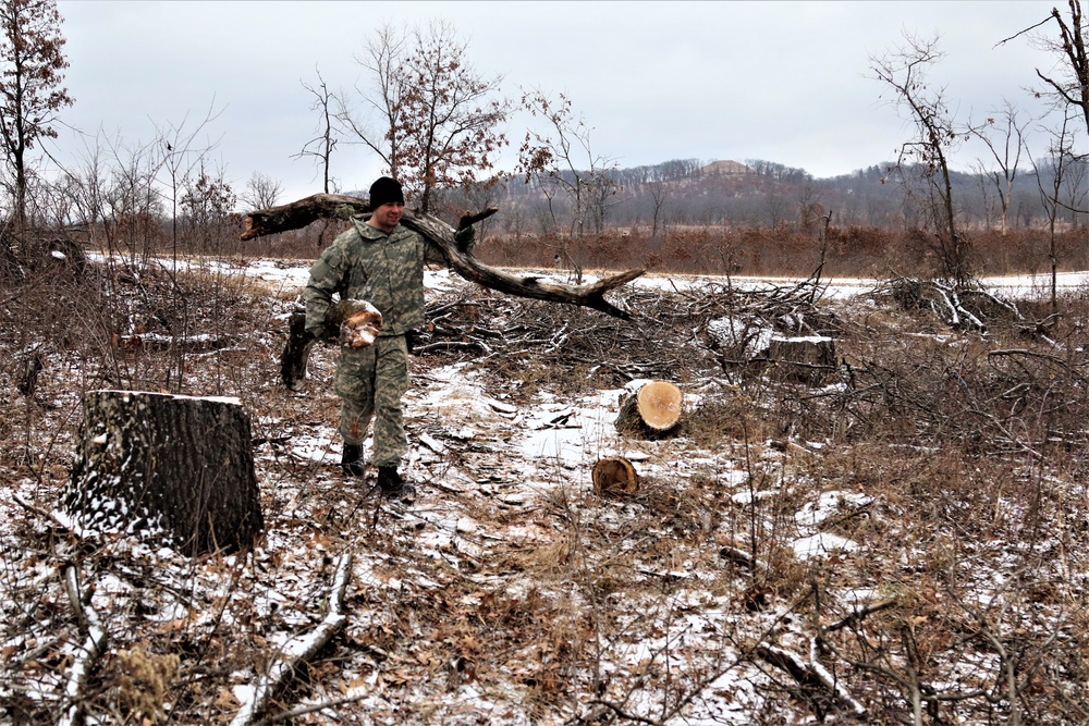 Cold-Weather Operations Course students build improvised shelters, survive outdoors