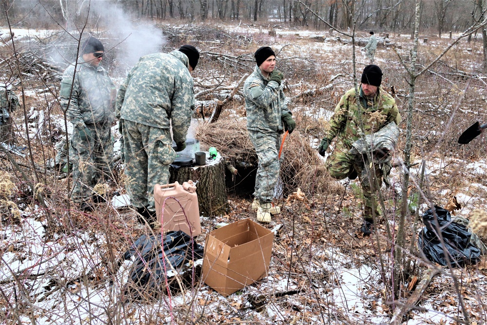 Cold-Weather Operations Course students build improvised shelters, survive outdoors