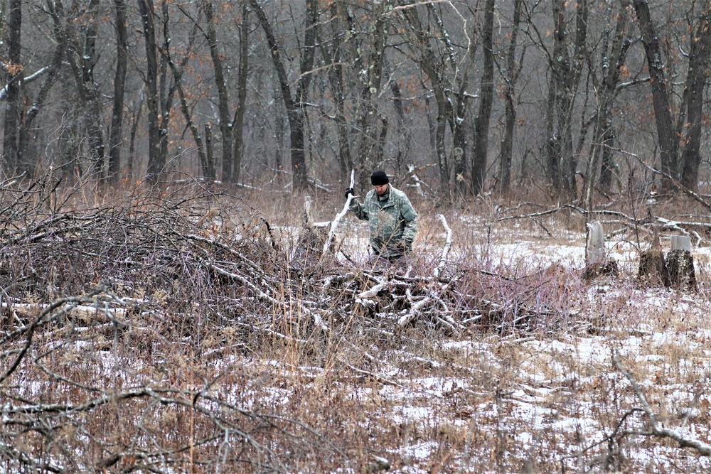 Cold-Weather Operations Course students build improvised shelters, survive outdoors