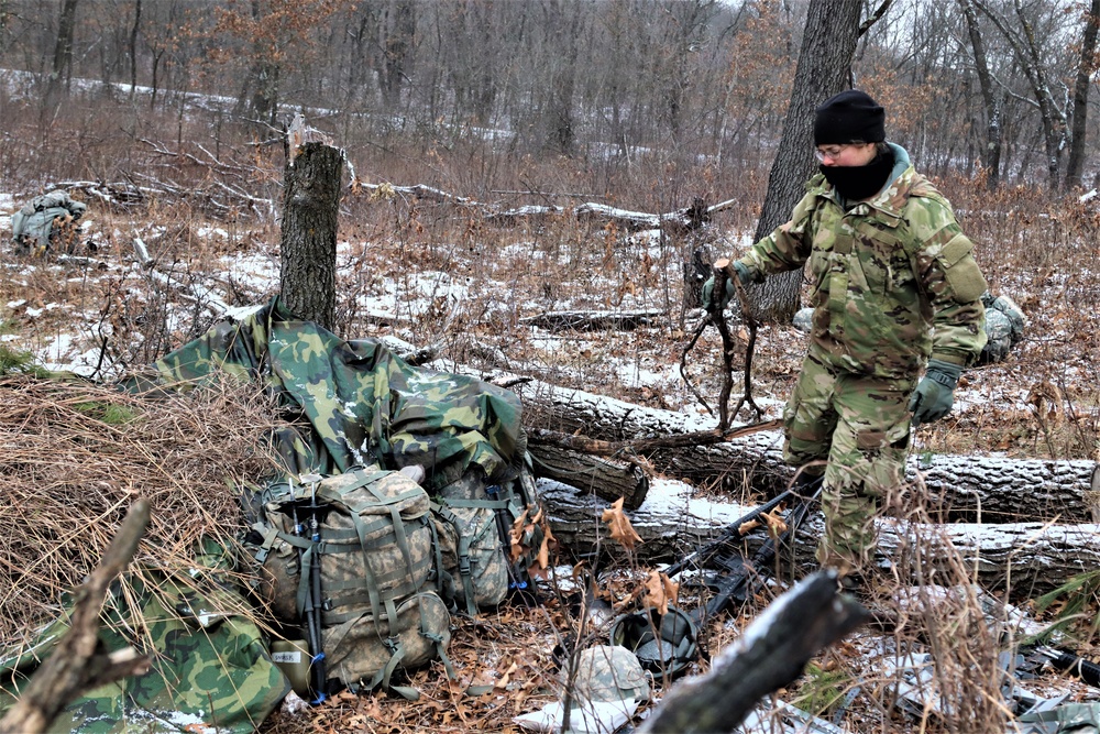 Cold-Weather Operations Course students build improvised shelters, survive outdoors